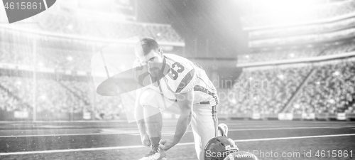 Image of American Football Player on big modern stadium field