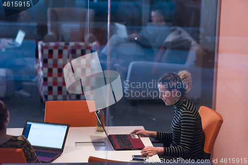Image of businesswoman using a laptop in startup office