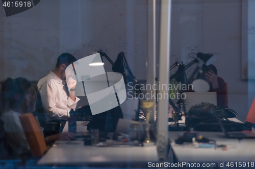 Image of businessman working using a laptop in startup office