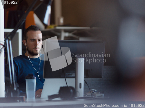 Image of businessman working using a laptop in startup office