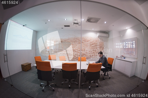 Image of businessman working using a laptop in startup office