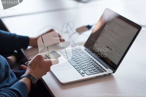 Image of businessman working using a laptop in startup office