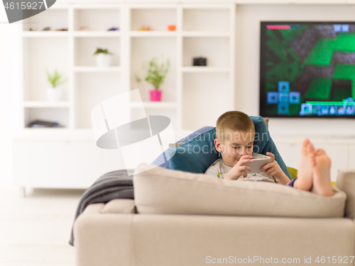 Image of little boy playing games on smartphone