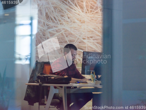 Image of businessman working using a computer in startup office