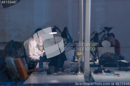Image of businessman working using a laptop in startup office