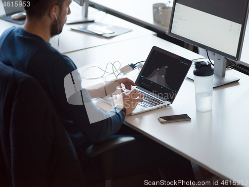 Image of businessman working using a laptop in startup office