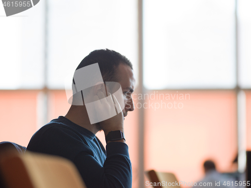 Image of business man listening music on headphones