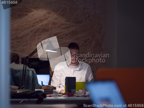 Image of businessman working using a laptop in startup office