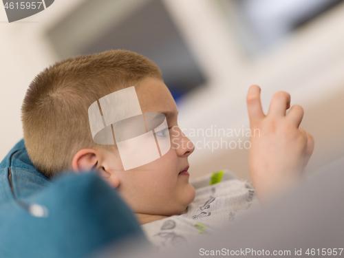 Image of little boy playing games on smartphone
