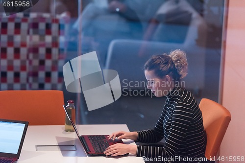 Image of businesswoman using a laptop in startup office