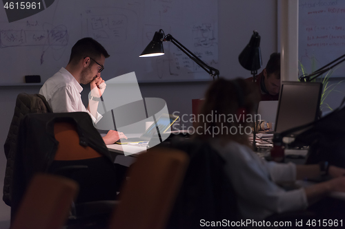 Image of businessman working using a laptop in startup office