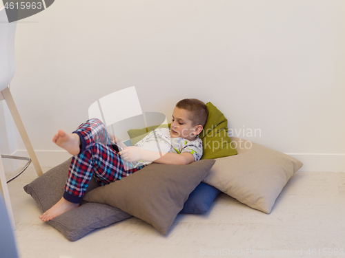 Image of little boy playing games on tablet computers