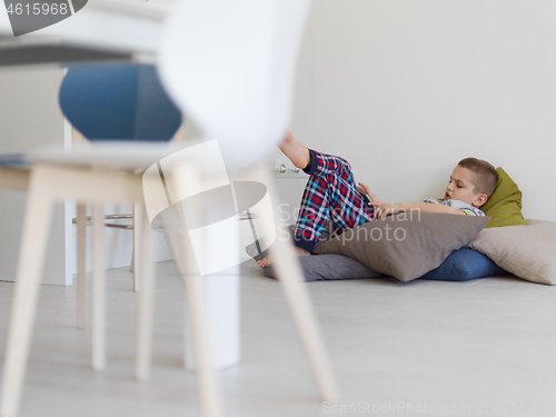 Image of little boy playing games on tablet computers