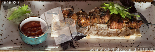 Image of shashlik on a barbecue skewer with sauce