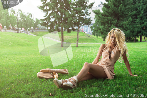 Image of Beauty blonde alone young woman resting in the park