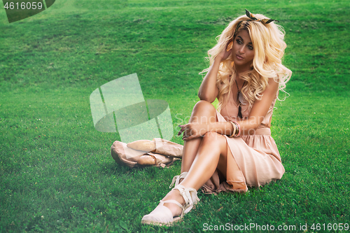 Image of eauty blonde alone young woman resting in the park