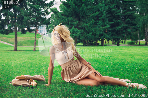 Image of Beauty blonde alone young woman resting in the park