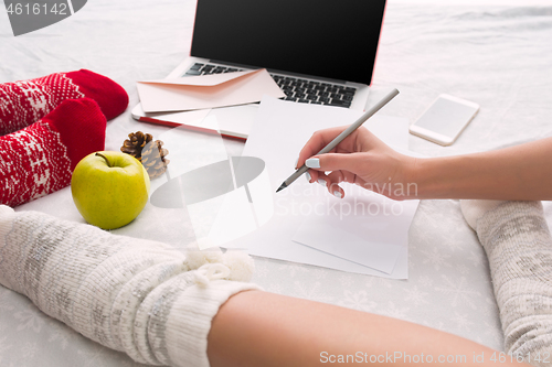 Image of caucasian couple at home using internet technology LLaptop and phone for people sitting on the floor