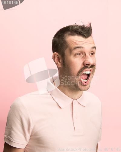 Image of The man screaming with open mouth isolated on pink background, concept face emotion