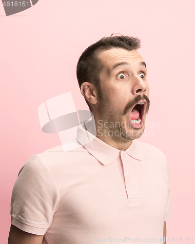 Image of The man screaming with open mouth isolated on pink background, concept face emotion