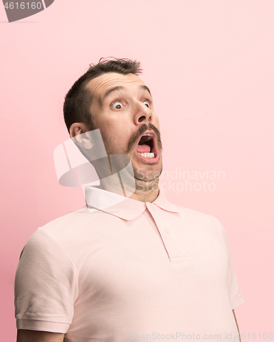 Image of The man screaming with open mouth isolated on pink background, concept face emotion