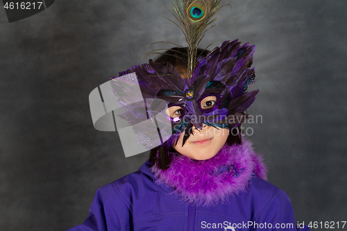 Image of Portrait of a young cute girl with a mask  looking at the camera