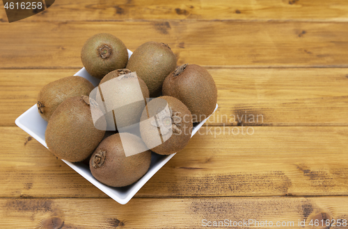 Image of Selection of hairy-skinned kiwifruit in a bowl on a table