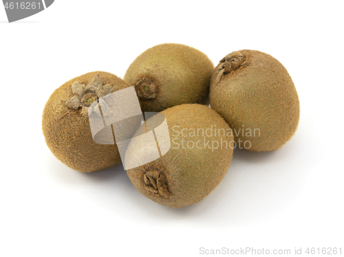 Image of Four whole kiwi fruits with hairy skins 