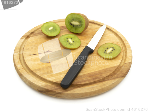 Image of Kitchen knife used to cut slice of healthy kiwi fruit