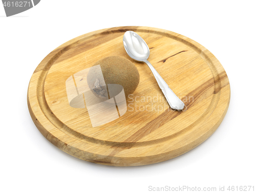 Image of Kiwi on a board, ready to eat with a spoon
