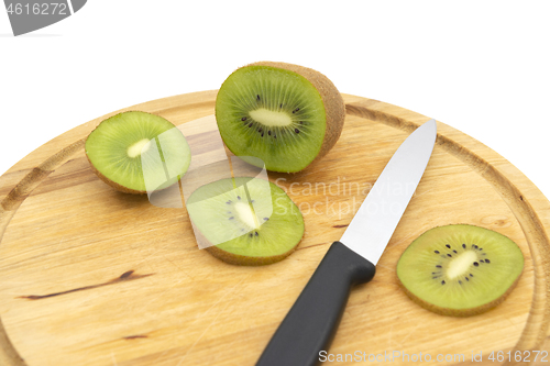 Image of Fresh green kiwi with a kitchen knife and cut slices