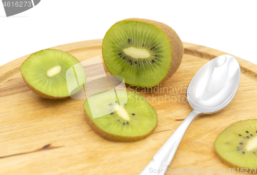 Image of Sliced healthy kiwifruit with a spoon on a wooden board