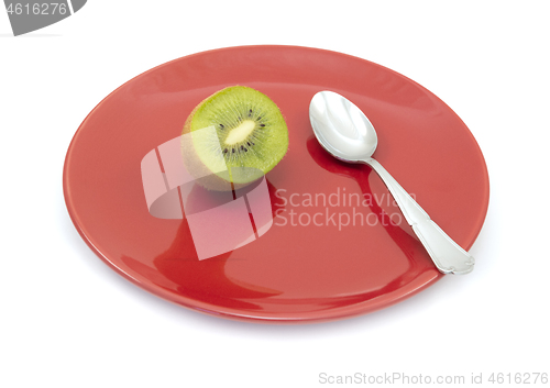 Image of Half a fresh kiwi on a plate with a spoon