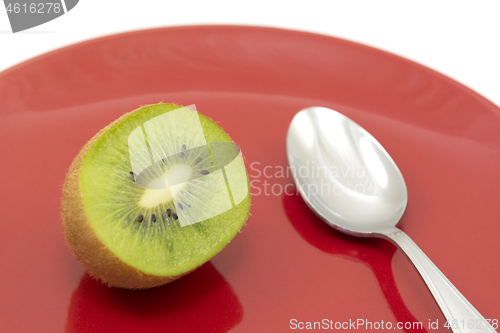 Image of Half kiwi fruit ready to eat with a spoon