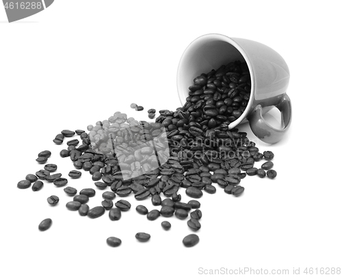 Image of Aromatic roasted coffee beans pour from a mug