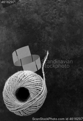 Image of Round ball of hessian twine unfurling 