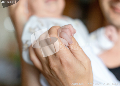 Image of Infant boy in the arms of dad