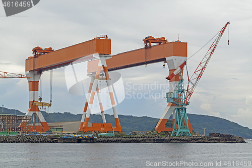 Image of Two huge shipbuilding Gantry Cranes at the shipyard