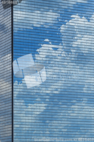 Image of Clouds reflected in windows of skyscraper