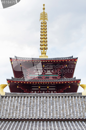 Image of Top of pagoda tower on light background with clouds