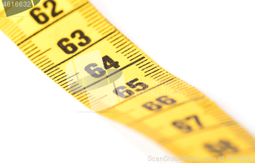 Image of Close-up of a yellow measuring tape isolated on white - 64