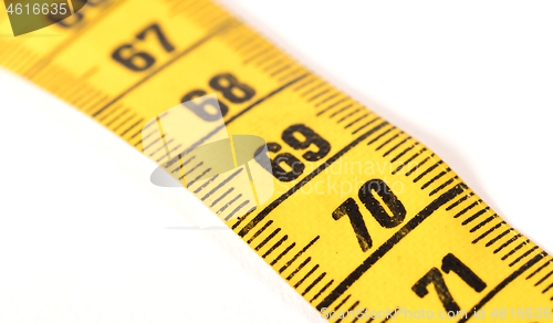 Image of Close-up of a yellow measuring tape isolated on white - 70