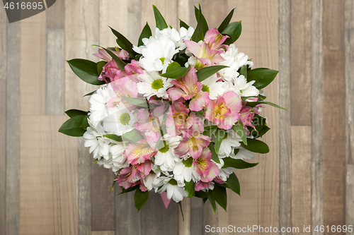 Image of Beautiful bouquet of fresh flowers on a wooden background