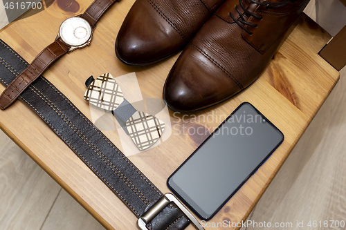 Image of Men&#39;s accessories: shoes, watches, belt, smartphone and bow tie, concept