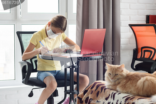 Image of Ill girl schoolgirl studies online via computer