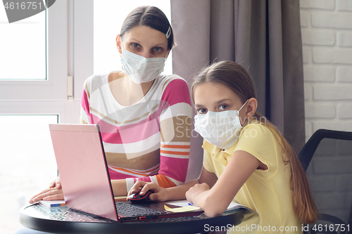 Image of The quarantined family in the isolation ward, mom and daughter doing homework, looked into the frame