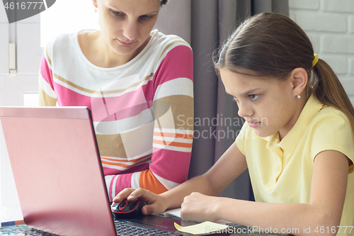 Image of Girl focused on homework online