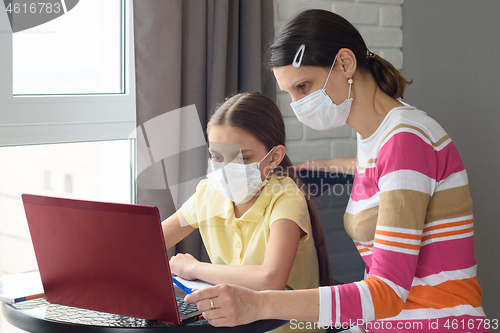 Image of quarantined girl and girl perform school tasks online