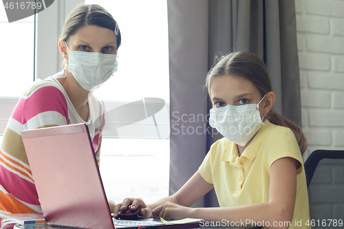 Image of Quarantine mom and daughter do home lessons online