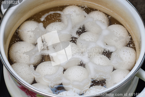 Image of Chicken eggs are boiled in a pan, close-up